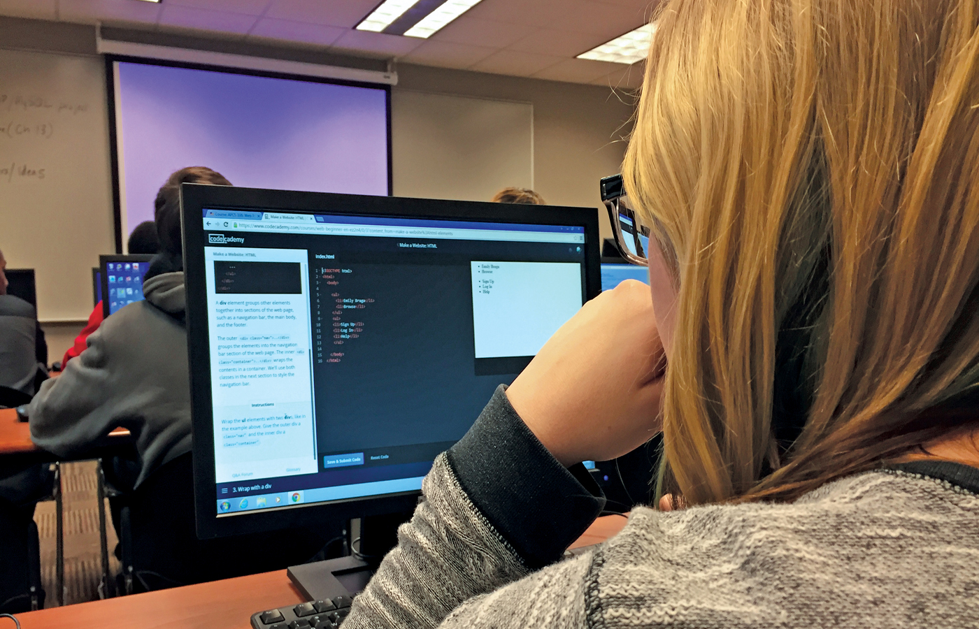 student examining computer code